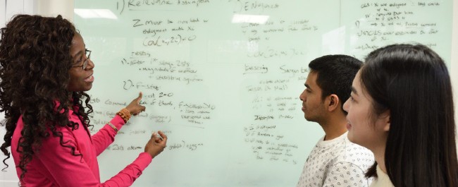 Students working in group at white board